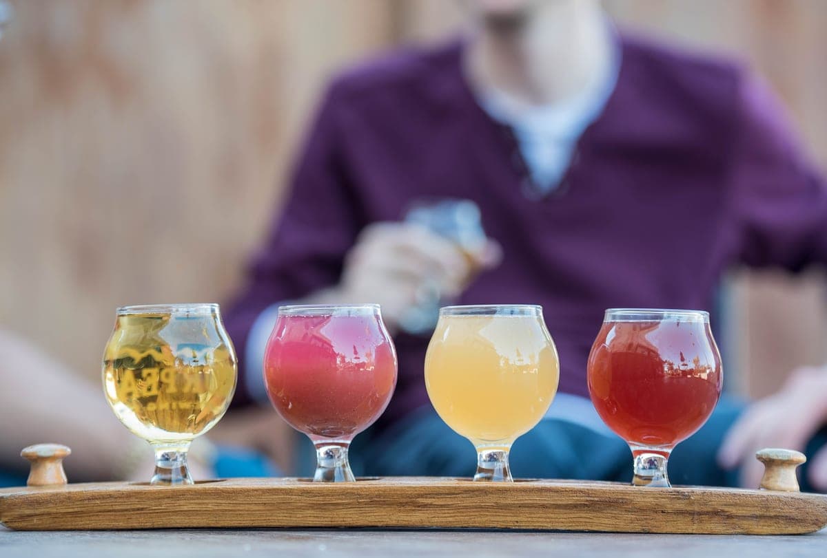 A flight of beer glasses on a bar