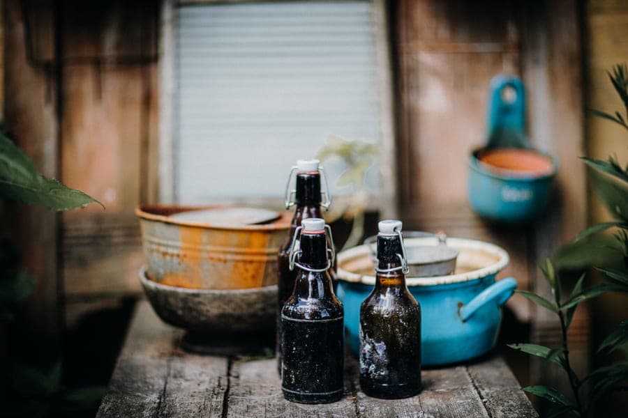 Homebrew starter kit with a fermenter, airlock and bottles